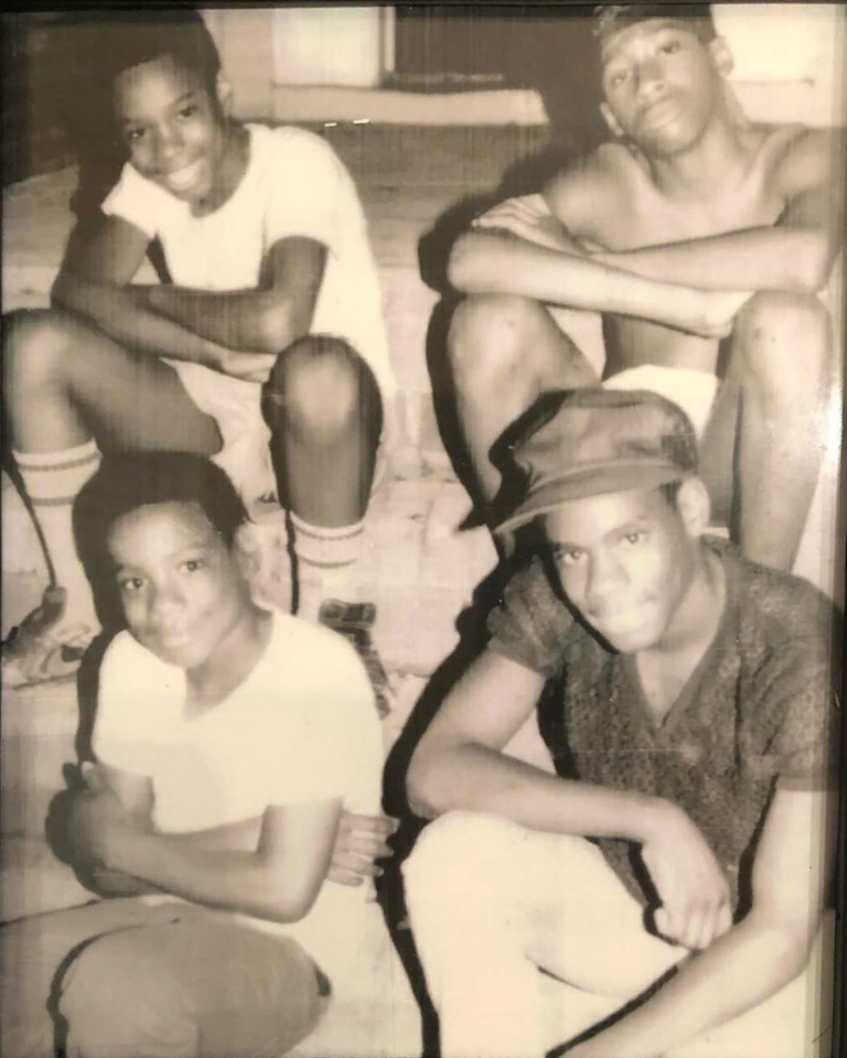 Brothers Freddy Hawkins, Amir Hawkins and Yusuf Hawkins with friend Christopher Graham sitting on the front stoop