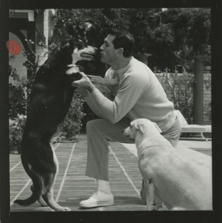 Rock Hudson at home with one of his many beloved dogs (1960s)