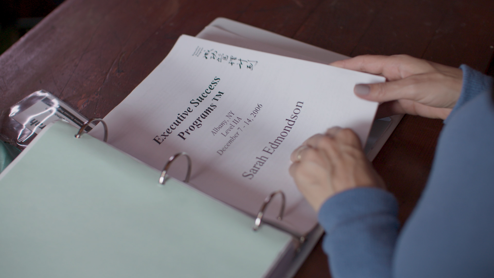 Sarah Edmondson reviewing her Executive Success Programs binder