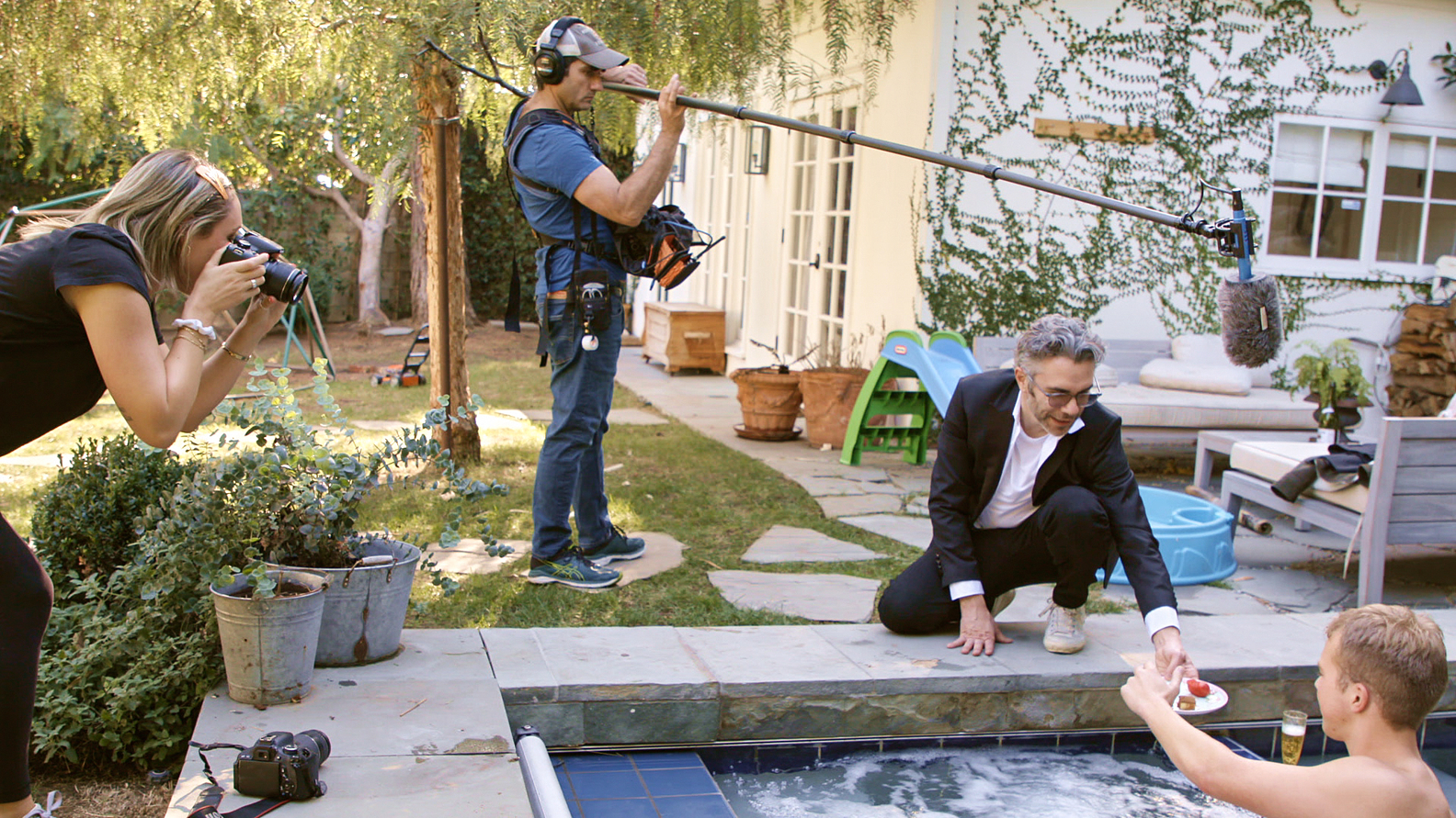 Photographer Ashley Wilhardt, Jesse Dwyer, Director Nick Bilton, and producer Wylie Heiner staging a fake photo shoot
