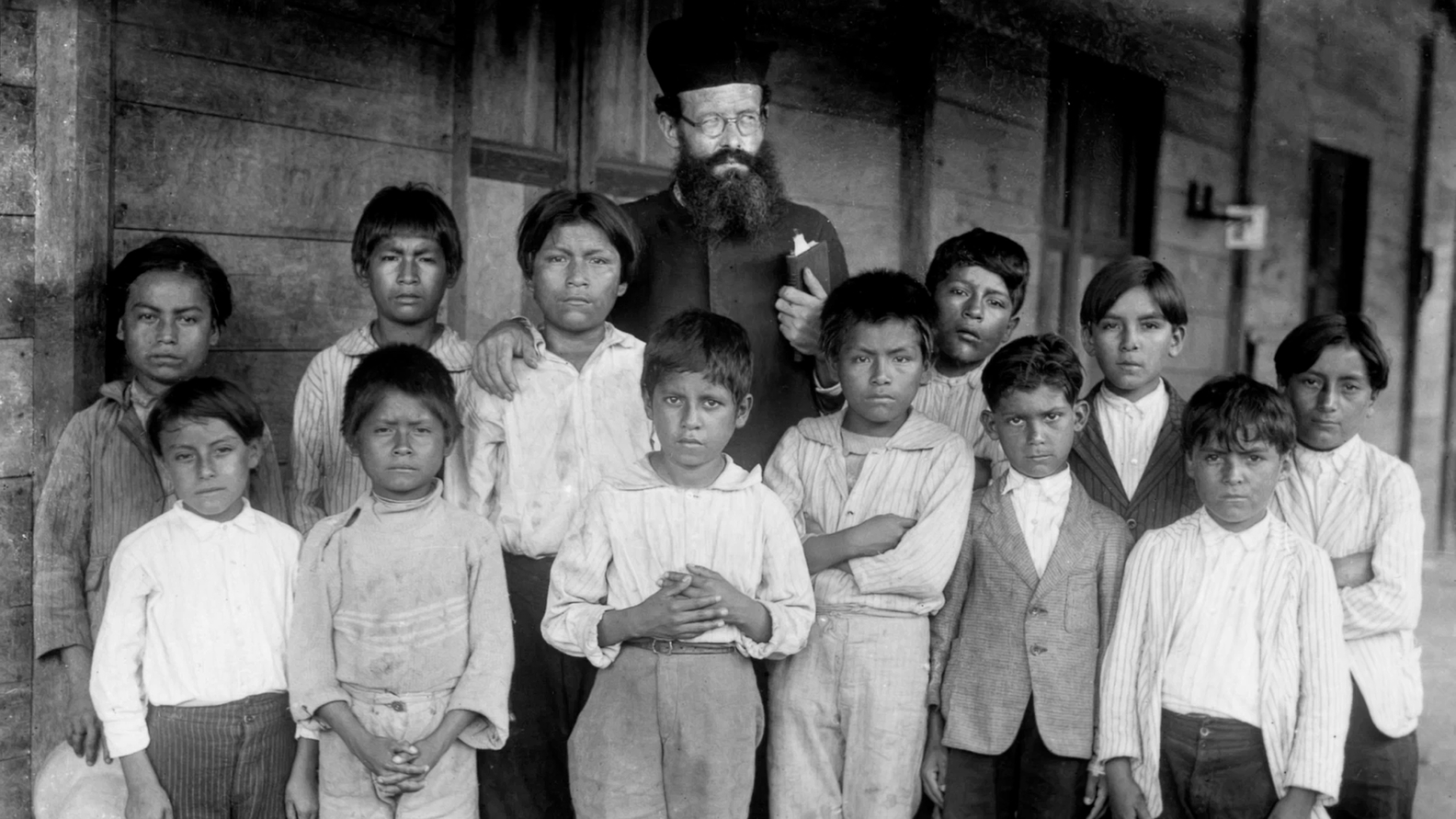 Missionary with indigenous Shuar children from Gualaquiza, Morona Santiago, Anya Yala Cultural Center (circa 1925- 1935)