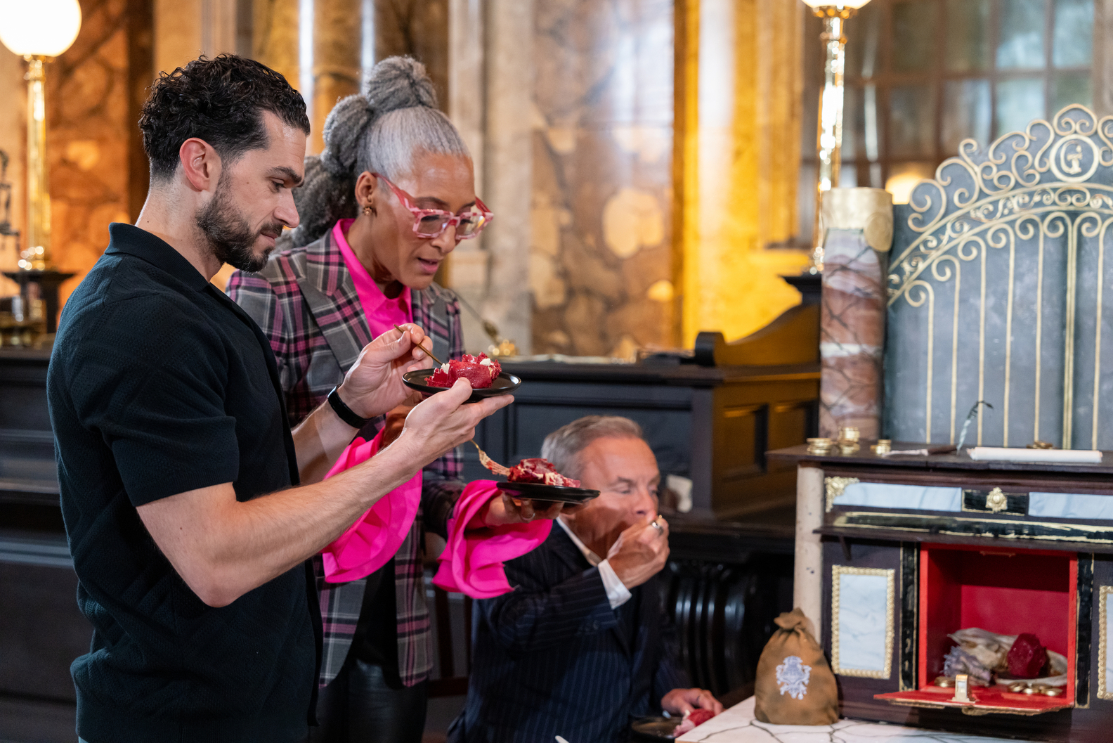 Judges Carla Hall and Jozef Youssef with guest judge Warwick Davis during judging, on Food Network's Harry Potter Wizards of Baking
