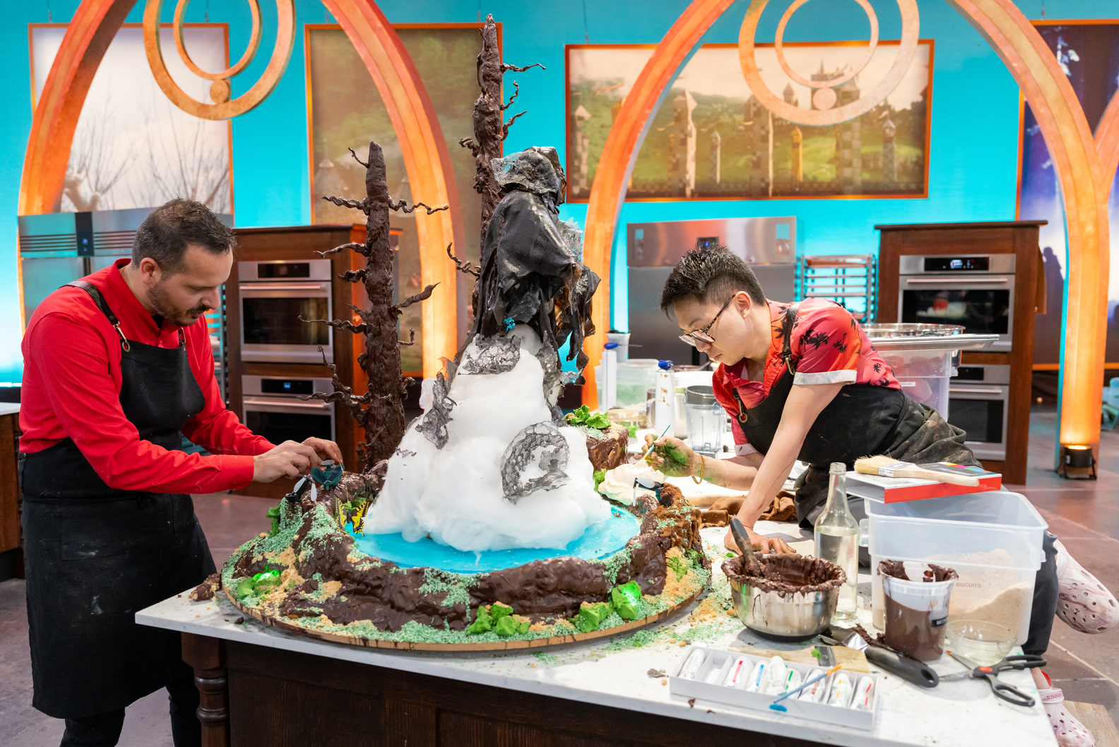 Competitors work on assembling their creation Harry Potter Wizards of Baking Food Network