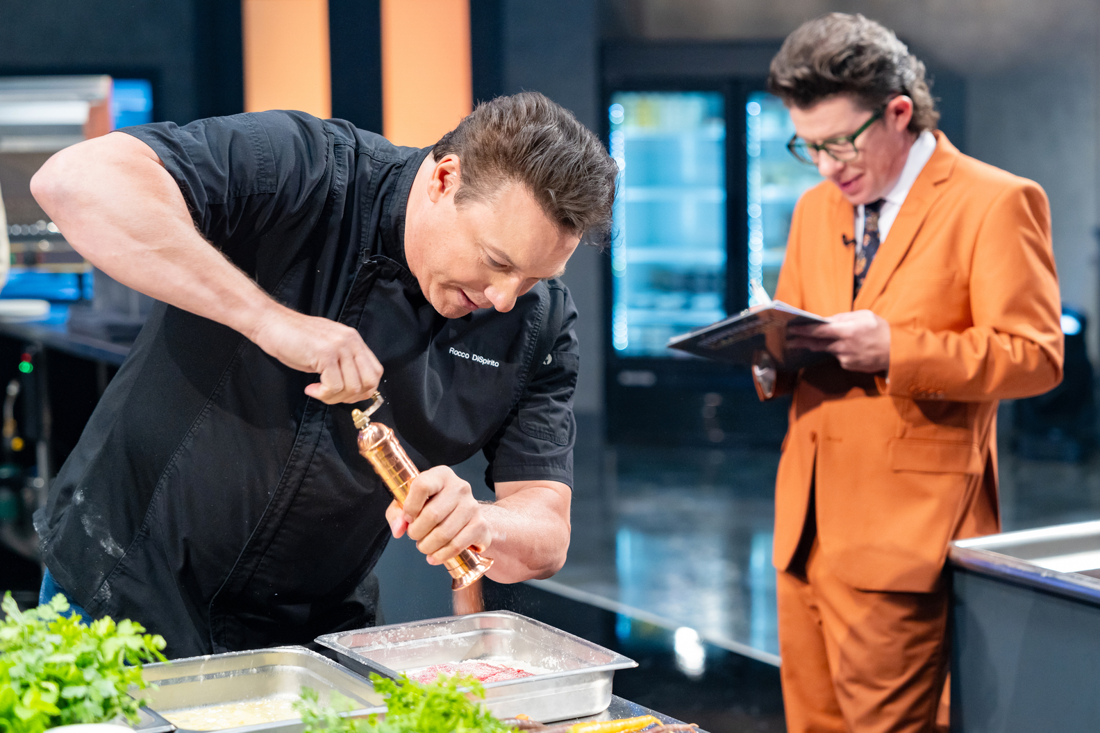 Rocco DiSpirito gets cooking as sideline reporter Justin Warner takes notes on Food Network's Tournament of Champions VI