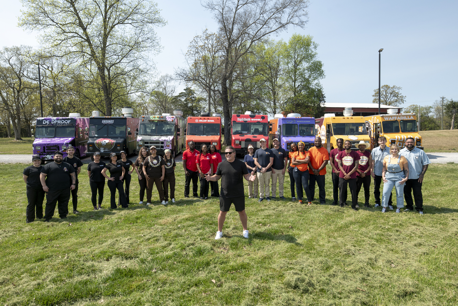 The Great Food Truck Race. Host Tyler Florence with the S19 competitors. Credit Food Network