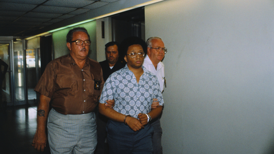 Men leading Wayne Williams in handcuffs, the suspect being detained in Atlanta murders (07/15/1981)
