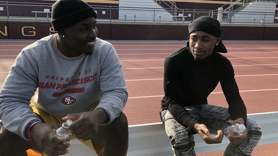 Former NFL player and Edison High School football coach, Lavelle Hawkins, with senior, Isaiah Evans