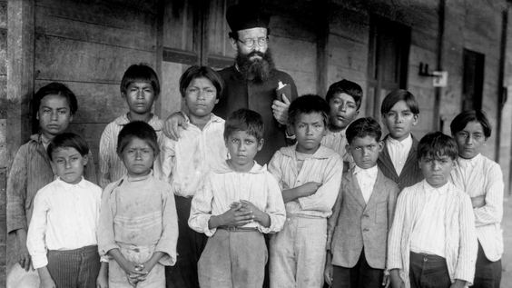 Missionary with indigenous Shuar children from Gualaquiza, Morona Santiago, Anya Yala Cultural Center (circa 1925- 1935)