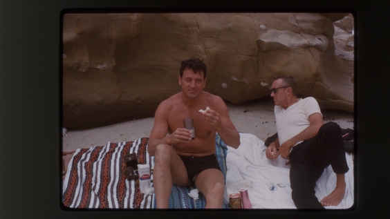 Rock Hudson (left) with a friend at a beach outing (1963)