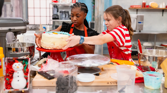camryn_williams_and_elsie_stark_prepare_a_cake_as_seen_on_food_network_s_kids_baking_championship_frosting_the_snowman.