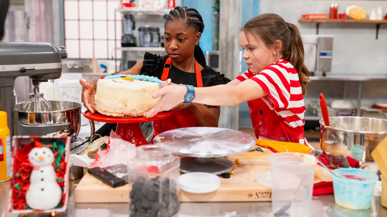 Contestants Camryn Williams and Elsie Stark prepare a cake, as seen on Food Network's Kids Baking Championship Frosting the Snowman