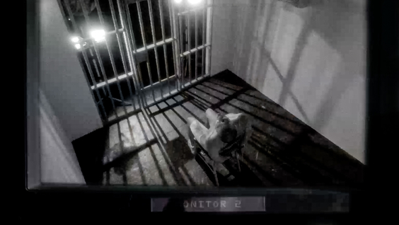 Recreation still of a detainee in a cell