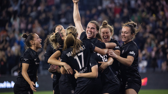 Angel City Football Club’s Vanessa Gilles (center), surrounded by teammates, including (from left) Ali Riley, Dani Weatherholt, Savannah McCaskill, and Megan Reid