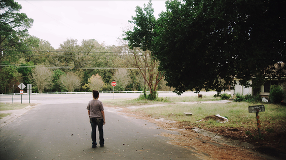 Jenna Arguijo standing down the road from the old Cantrell home she lived in