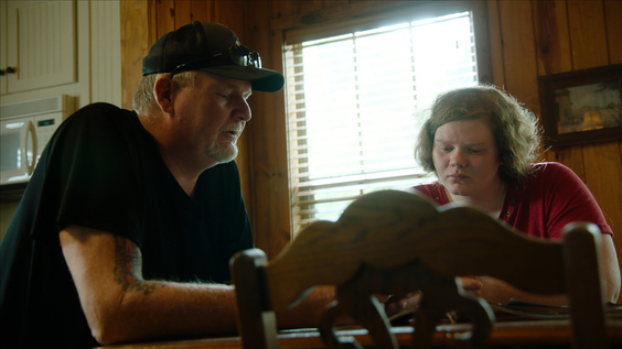 Jimmy with his daughter Gabby looking through old family photos