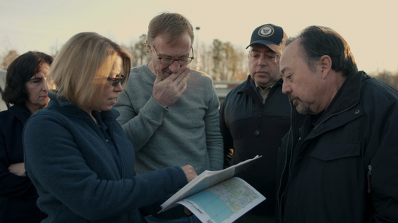 Stephen Pandos (Back Center) meets with investigators